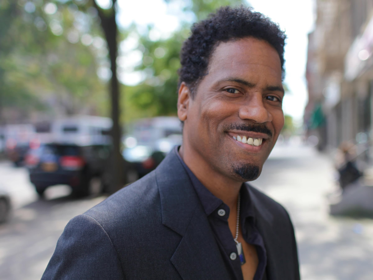 Daniel Carlton smiling on a New York City street
